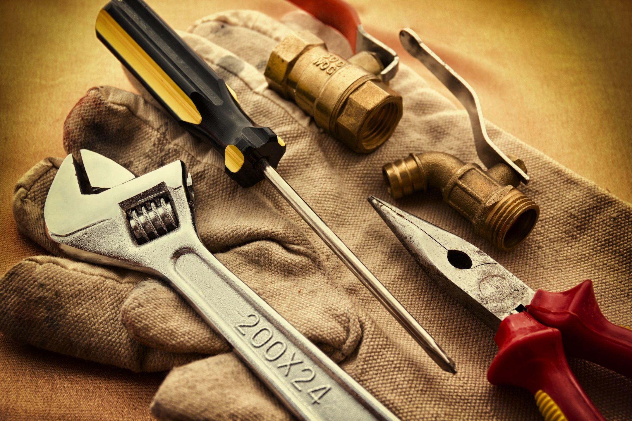 qtq80-zZodMY Wrench screwdriver and pliers sitting on tan cloth